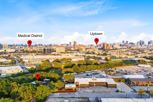 an aerial view of a house with outdoor space and trees all around