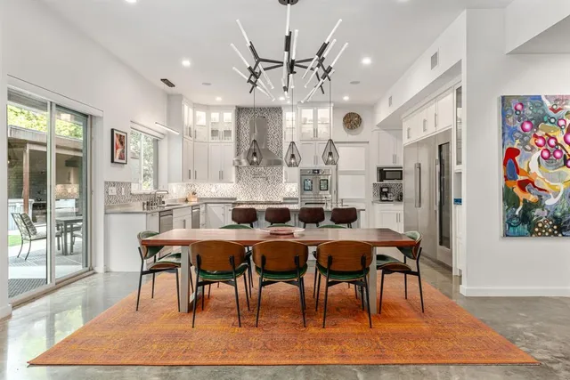a view of a dining room with furniture a chandelier and wooden floor