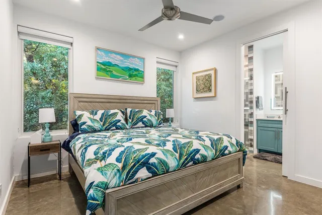 a bed sitting in a bedroom next to a window