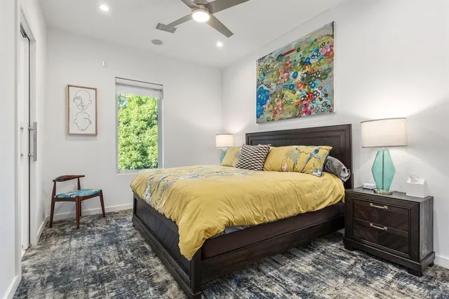 a bed sitting in a bedroom next to a window