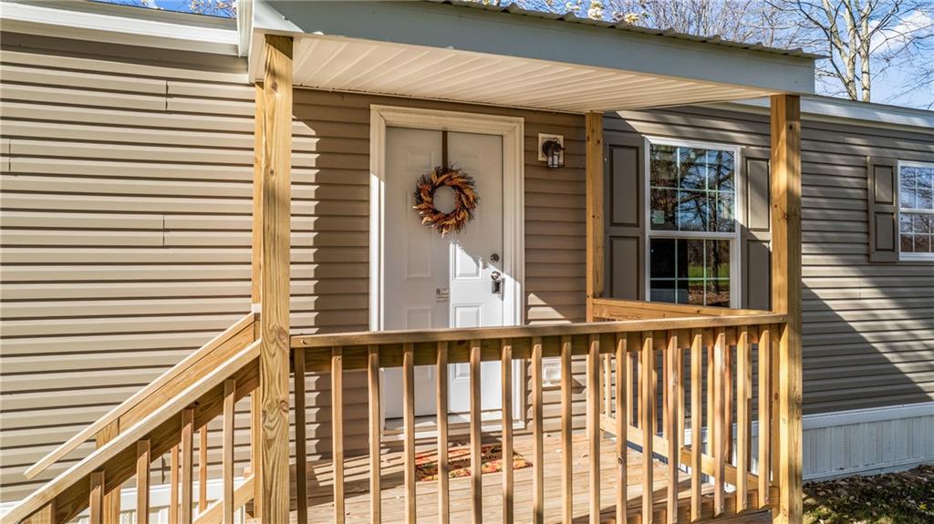 69 South Summit Road, Unit 102 Greenville, PA 16125 - Photo 2 of 24 a view of a balcony with wooden floor and fence