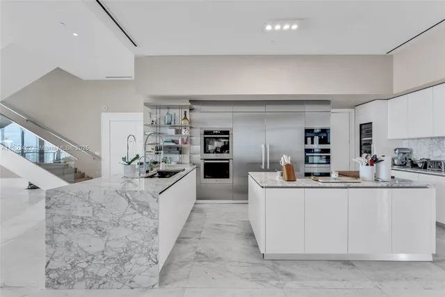 a kitchen with stainless steel appliances granite countertop a sink counter space cabinets and a counter top space