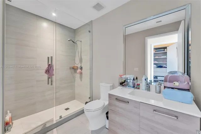 a bedroom with a bed and large windows