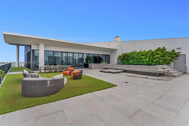 a view of a house with patio and a yard
