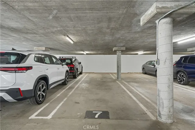 a view of garage with a car parked in it