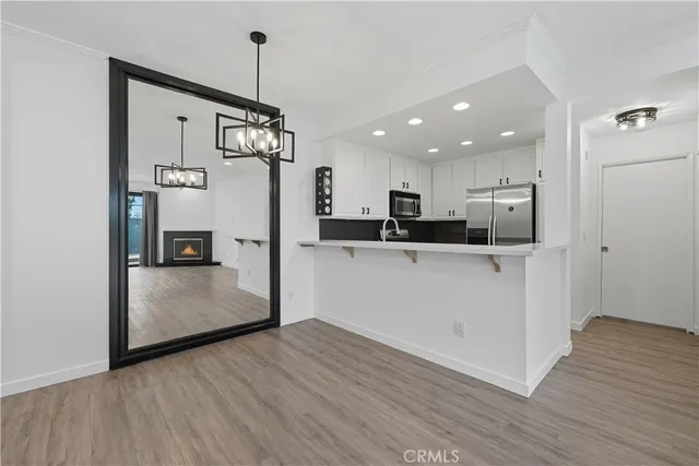 a kitchen with stainless steel appliances granite countertop a refrigerator a sink and a stove