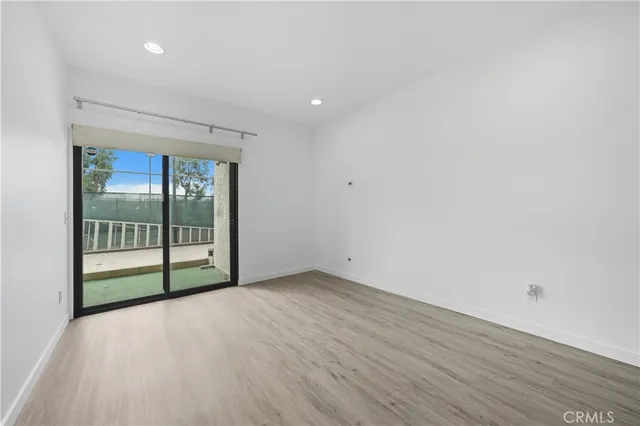 a view of a room with wooden floor and windows