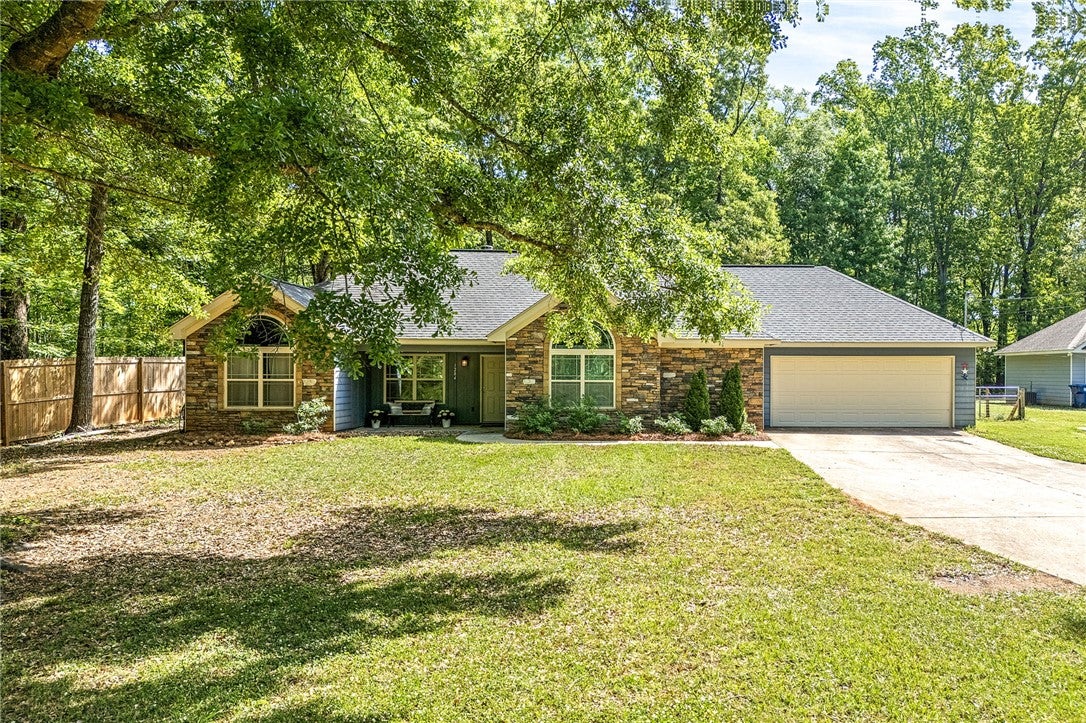 This charming home offers a perfect blend of comfort and natural beauty, featuring a spacious yard.