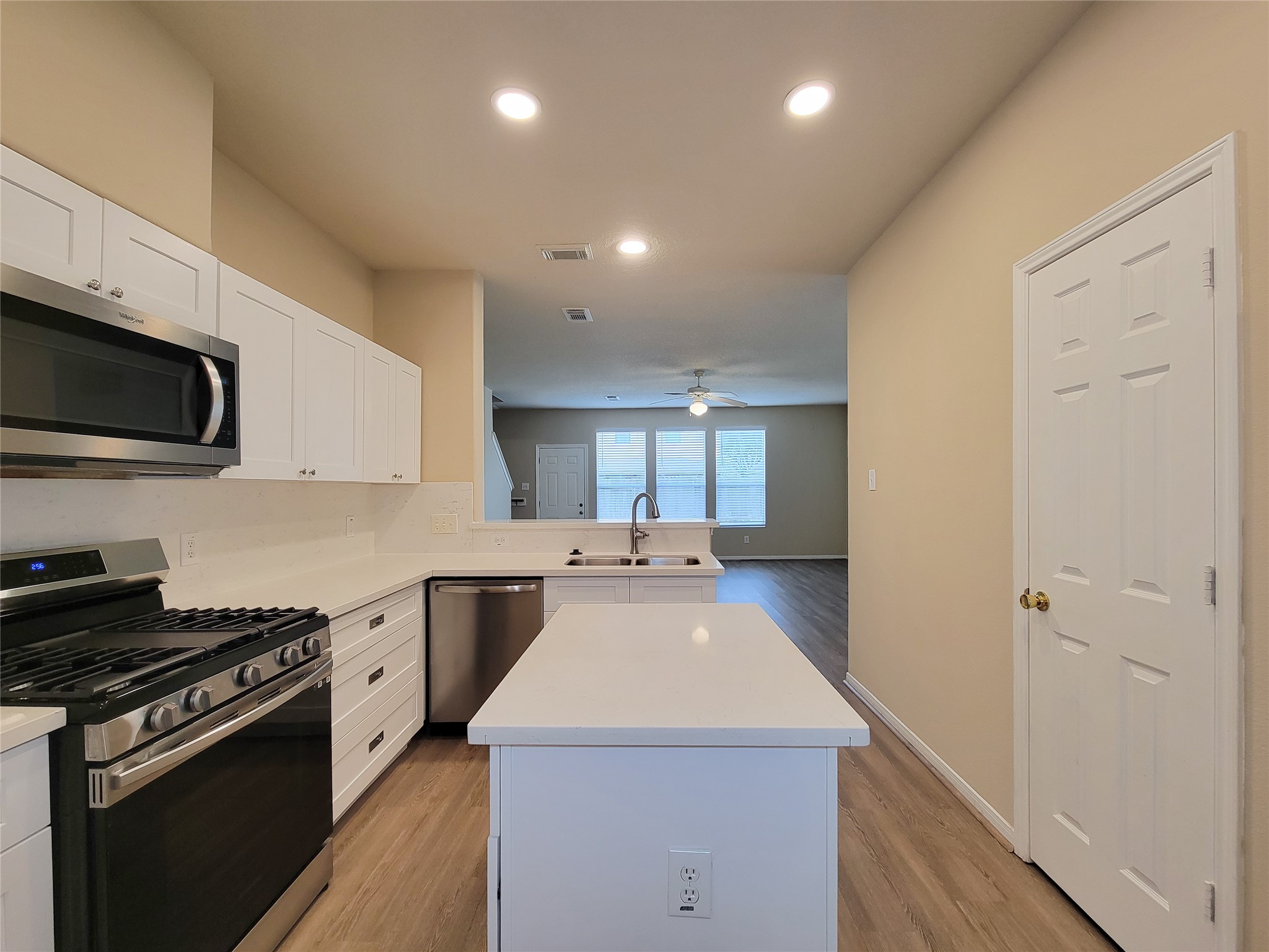 19338 Harvest Stream Way Houston, TX 77084 - Photo 15 of 49 a kitchen with a sink a stove and cabinets