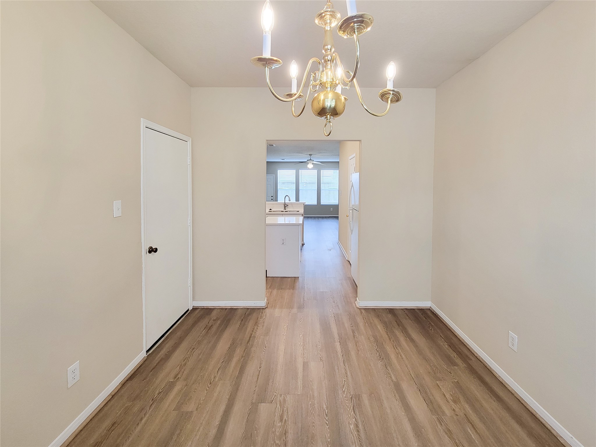 19338 Harvest Stream Way Houston, TX 77084 - Photo 20 of 49 a view of a room with wooden floor and chandelier