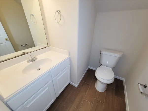 a bathroom with a sink toilet and vanity