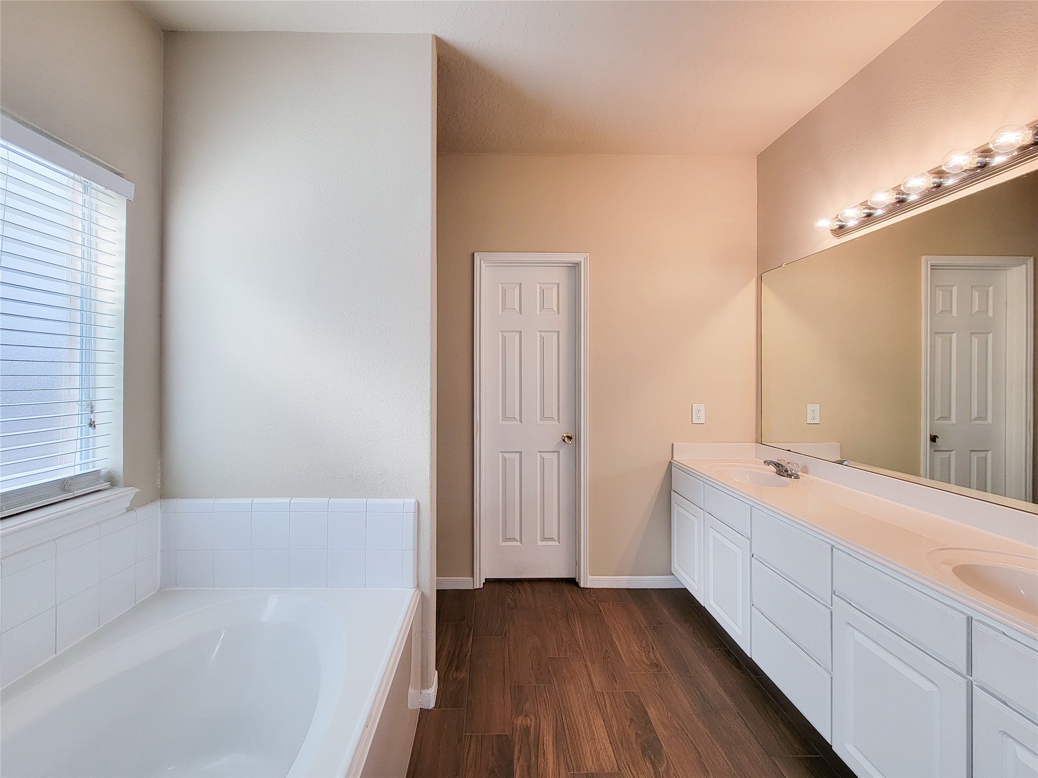 19338 Harvest Stream Way Houston, TX 77084 - Photo 27 of 49 a bathroom with a tub sink and mirror