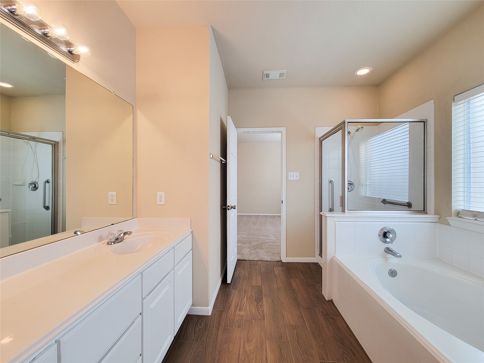 19338 Harvest Stream Way Houston, TX 77084 - Photo 31 of 49 a spacious bathroom with a bathtub shower and sink