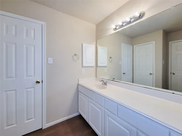 a spacious bathroom with a vanity and a mirror