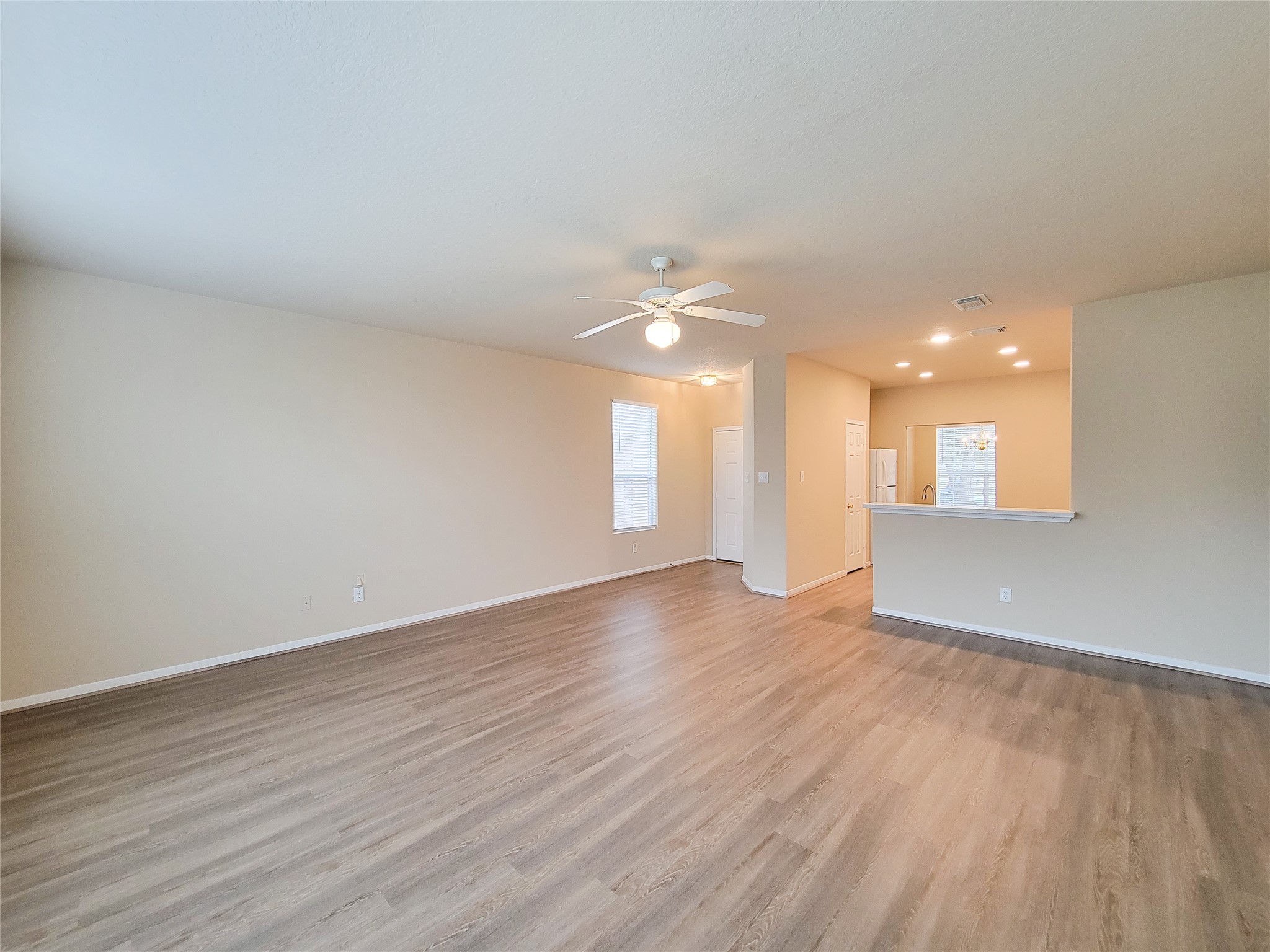 19338 Harvest Stream Way Houston, TX 77084 - Photo 10 of 49 a view of an empty room with wooden floor and a window