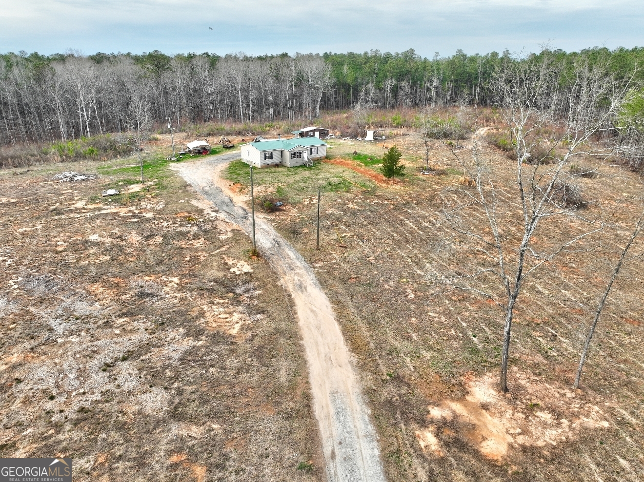 310 Bottoms Road Barnesville, GA 30204 - Photo 1 of 1 a view of a backyard of a house with a yard and outdoor seating