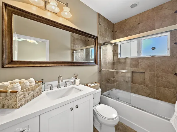 a bathroom with a sink a mirror and a toilet