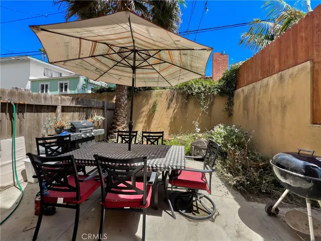 a view of a chairs and table in patio