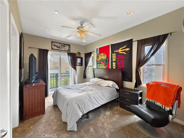 a bedroom with a bed mirror and window