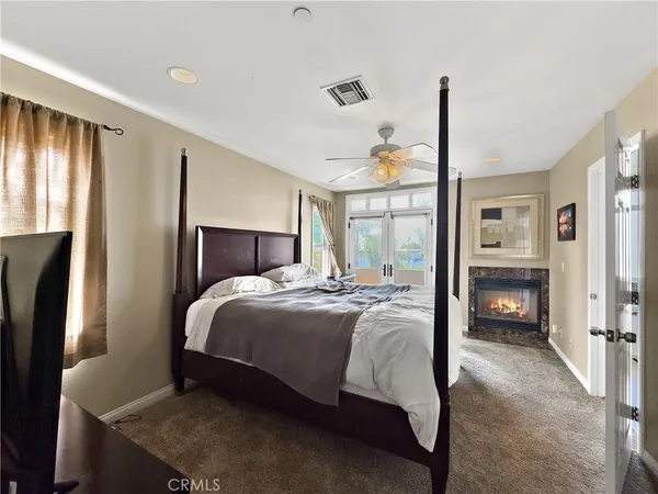 a bedroom with a bed window and a table