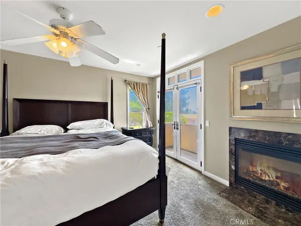 a bedroom with a bed and a fireplace