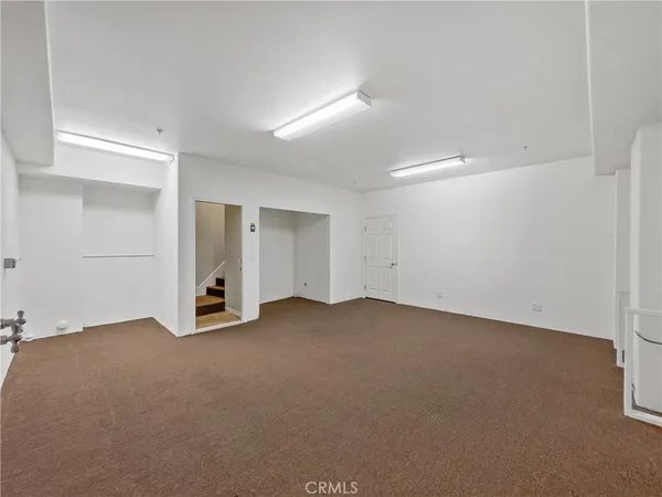 an empty room with closet and windows