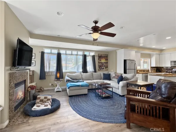 a living room with fireplace furniture and a flat screen tv