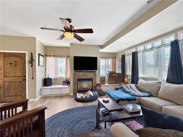 a living room with furniture a fireplace and a flat screen tv