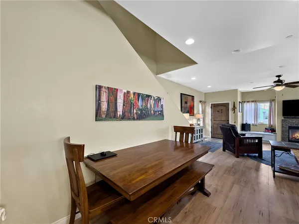 a living room with dining table and wooden floor