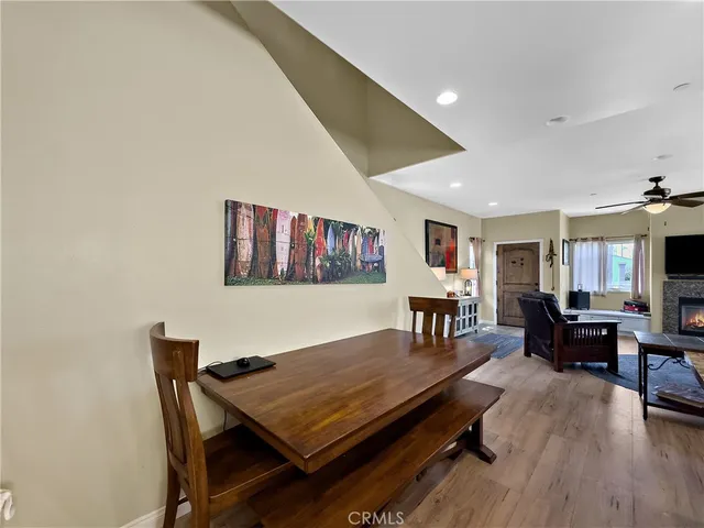 a living room with dining table and wooden floor