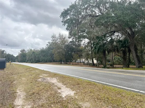 a view of a dry yard with a barn