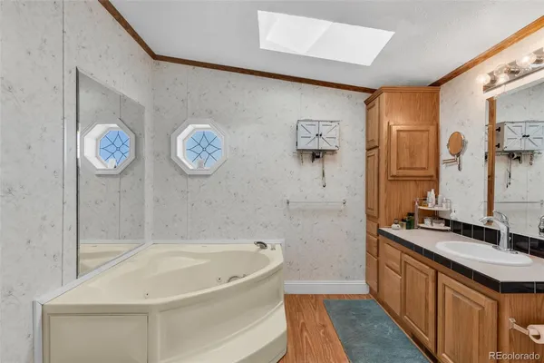 a bathroom with a granite countertop toilet sink and mirror