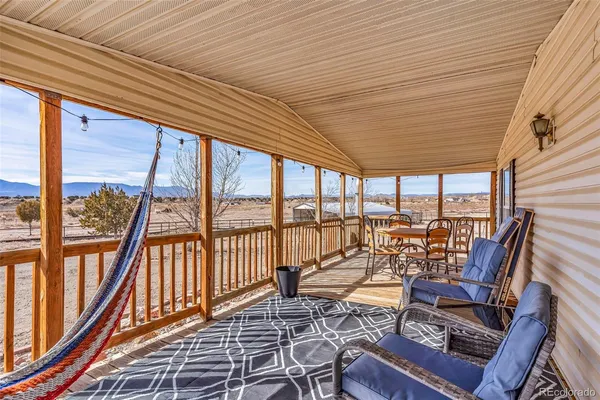 a view of a patio with a table chairs and a backyard