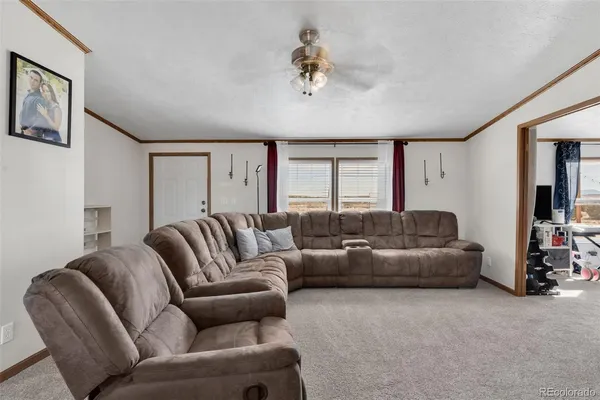 a view of a livingroom with furniture and a window