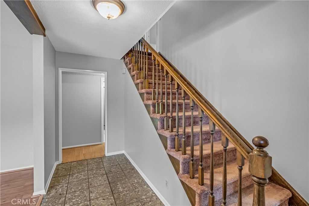 5544 Wentworth Drive Riverside, CA 92505 - Photo 12 of 29 a view of staircase with wooden floor and white walls