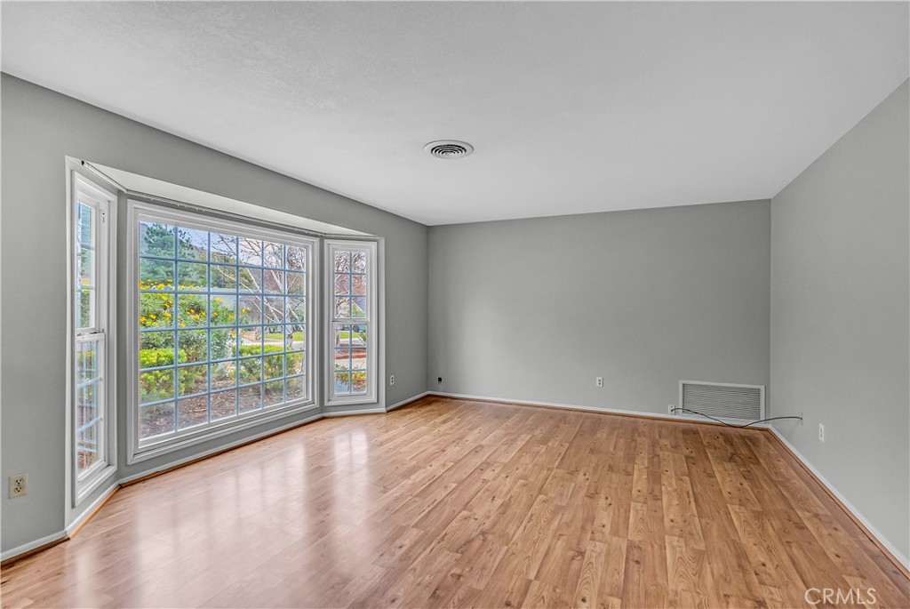 5544 Wentworth Drive Riverside, CA 92505 - Photo 2 of 29 a view of an empty room with wooden floor and a window