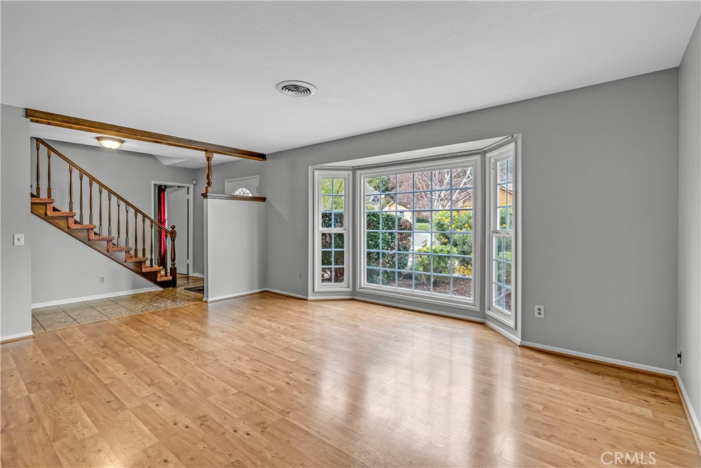 5544 Wentworth Drive Riverside, CA 92505 - Photo 3 of 29 a view of an empty room with wooden floor and a window