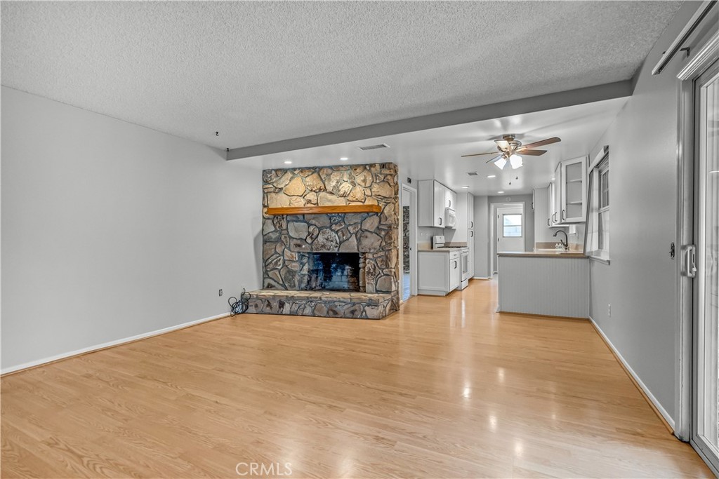 5544 Wentworth Drive Riverside, CA 92505 - Photo 4 of 29 a view of an empty room with a fireplace and a window