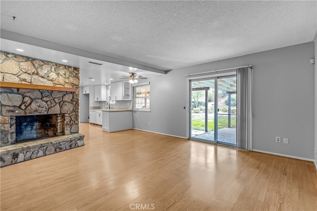 5544 Wentworth Drive Riverside, CA 92505 - Photo 5 of 29 wooden floor fireplace and windows in an empty room