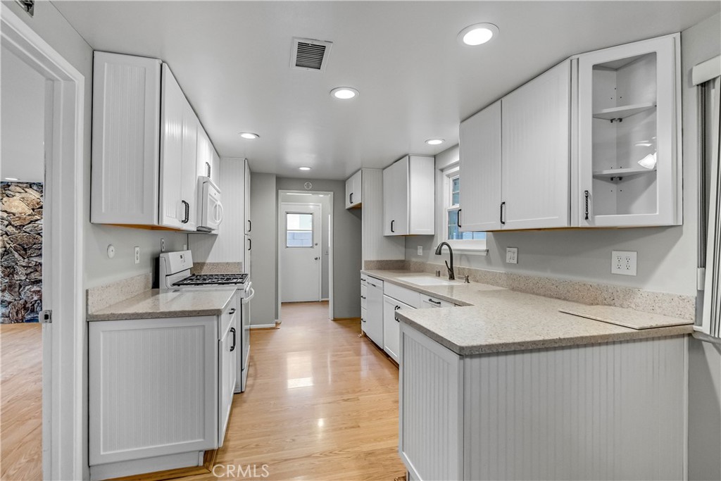 5544 Wentworth Drive Riverside, CA 92505 - Photo 7 of 29 a kitchen with stainless steel appliances granite countertop a sink stove and cabinets