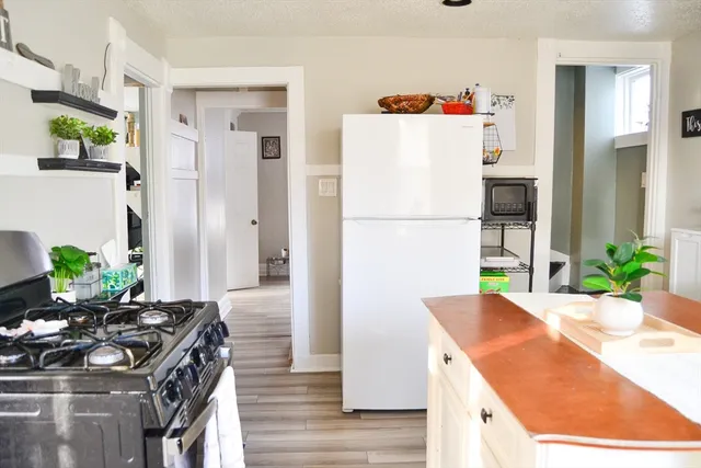 a kitchen with a stove a refrigerator and a dining table