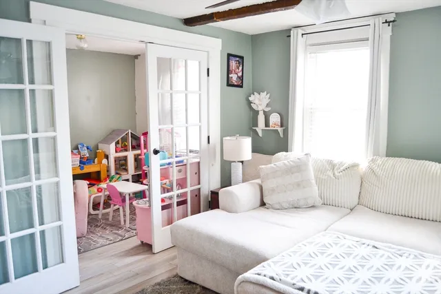 a bedroom with furniture and a window