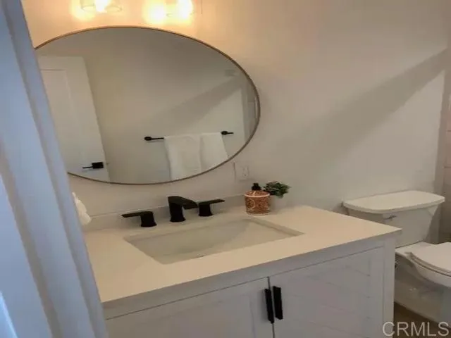 a bathroom with a sink and mirror