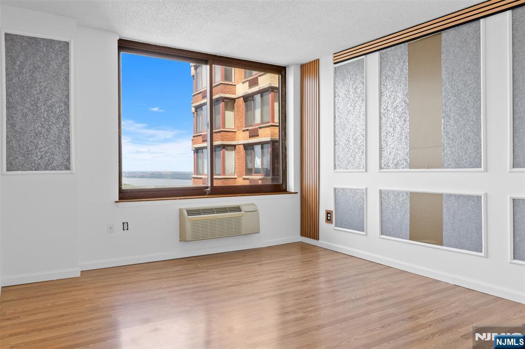 100 Old Palisade Road, Unit 3215 Fort Lee, NJ 07024 - Photo 21 of 43 a view of an empty room with wooden floor and a window