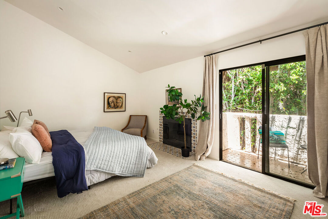 1916 Overland Avenue, Unit 2 Los Angeles, CA 90025 - Photo 11 of 17 a bedroom with a large bed and a large window