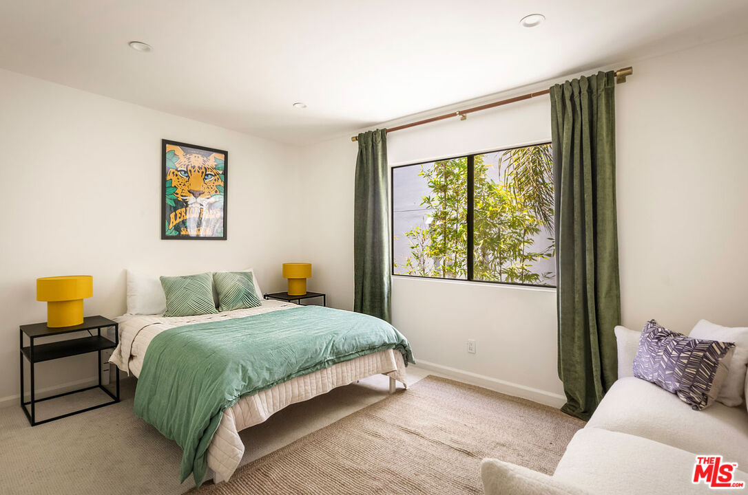 1916 Overland Avenue, Unit 2 Los Angeles, CA 90025 - Photo 14 of 17 a bedroom with a bed and a large window