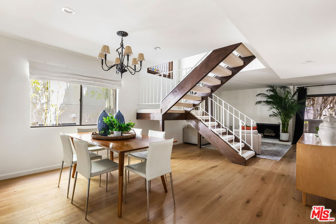 1916 Overland Avenue, Unit 2 Los Angeles, CA 90025 - Photo 6 of 17 a dining room with wooden floor table and chairs