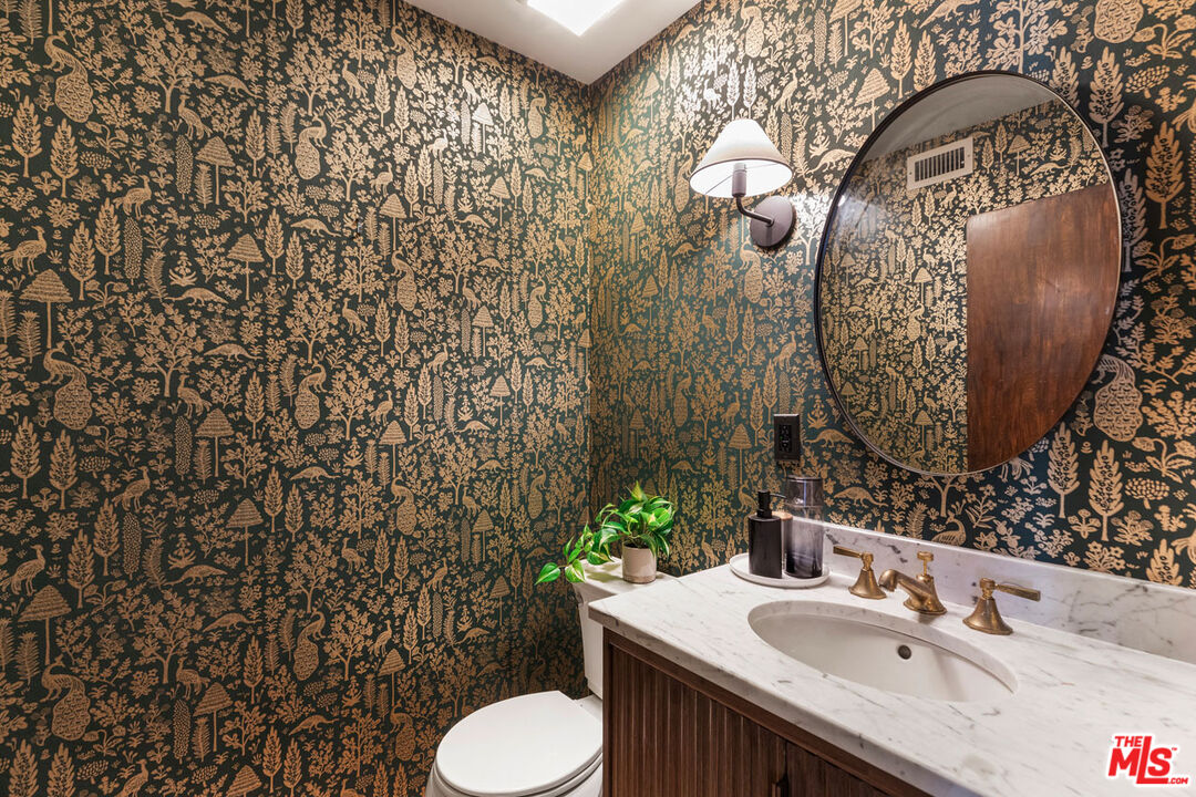 1916 Overland Avenue, Unit 2 Los Angeles, CA 90025 - Photo 9 of 17 a bathroom with a sink toilet and mirror