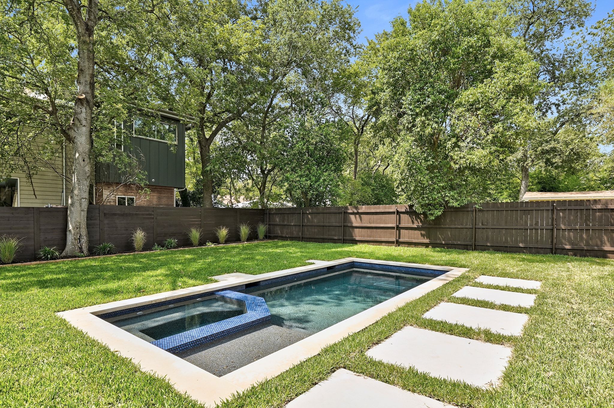 1705 Cullen Avenue Austin, TX 78757 - Photo 2 of 35 a view of a backyard with wooden fence and a large tree