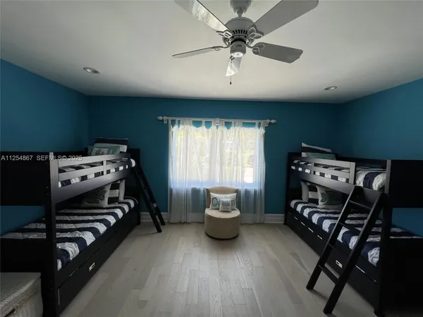 a bedroom with furniture and a window